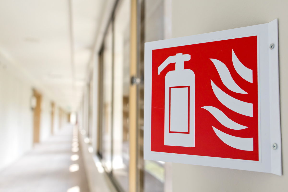 Fire extinguisher sign in the building corridor
